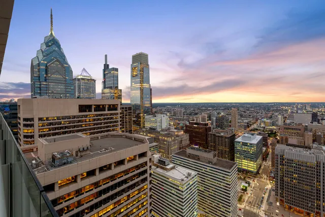 Twilight property exterior with warm sky